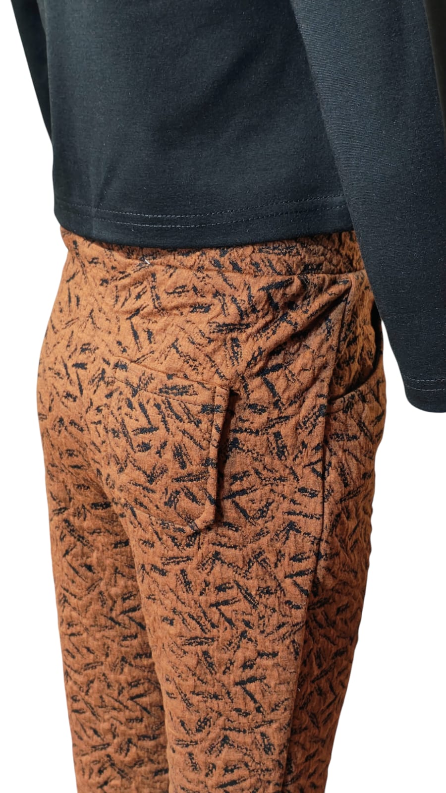 Eurynome Kidswear Girls—Sequin-styled black tencel top with butterfly and flower embellishments, paired with textured woven animal-pattern jeggings. Nature meets fashion for ages 3–9.