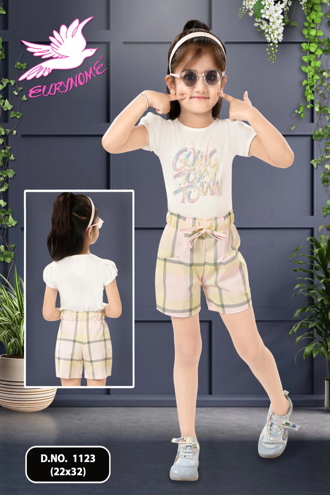 Eurynome Kidswear Girls—Going To Town and taking charge! Bold check shorts and a vibrant sticker top prove outdoor play is for girls who lead, laugh, and play as hard as anyone. Ages 3–9.