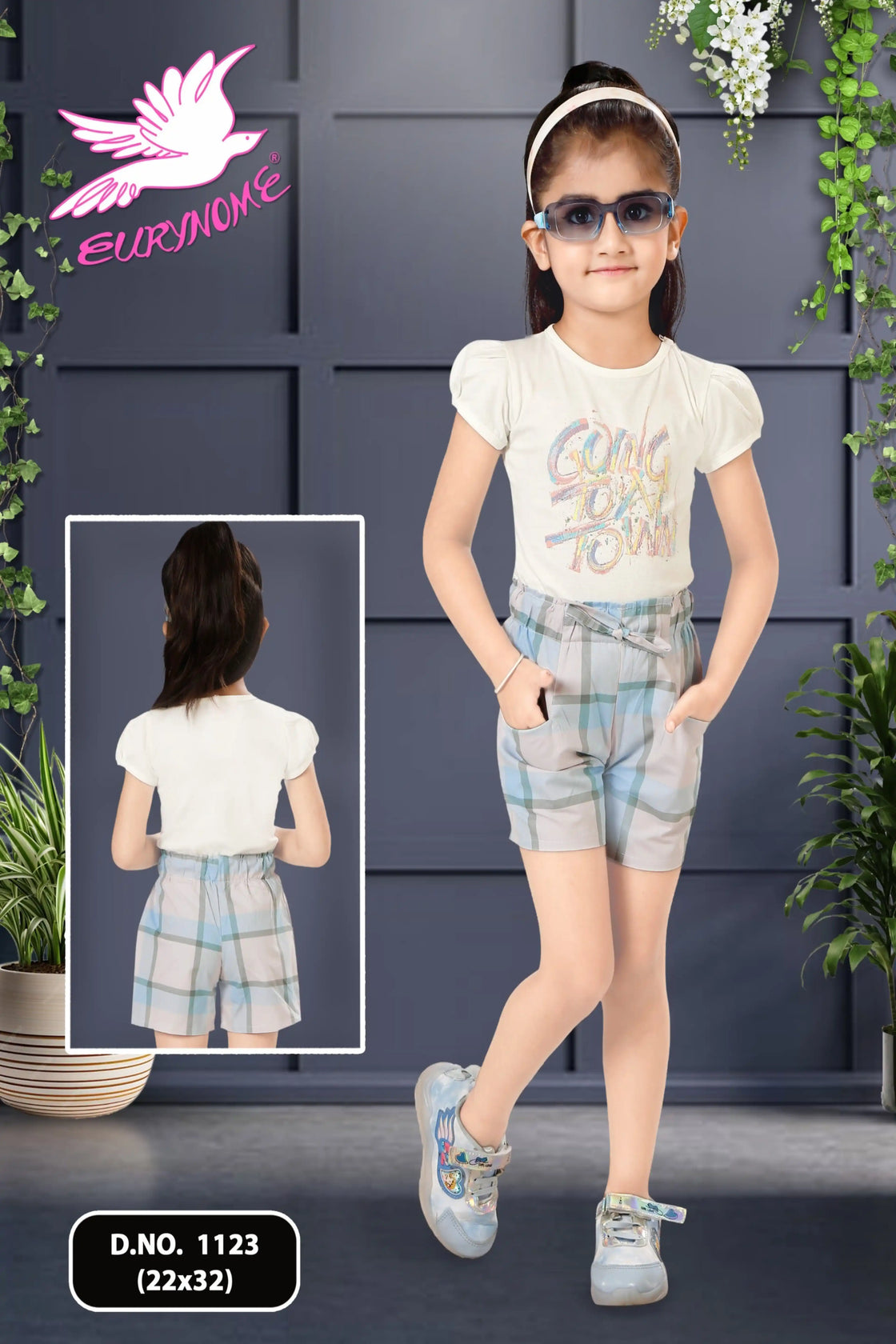 Eurynome Kidswear Girls—Going To Town and taking charge! Bold check shorts and a vibrant sticker top prove outdoor play is for girls who lead, laugh, and play as hard as anyone. Ages 3–9.