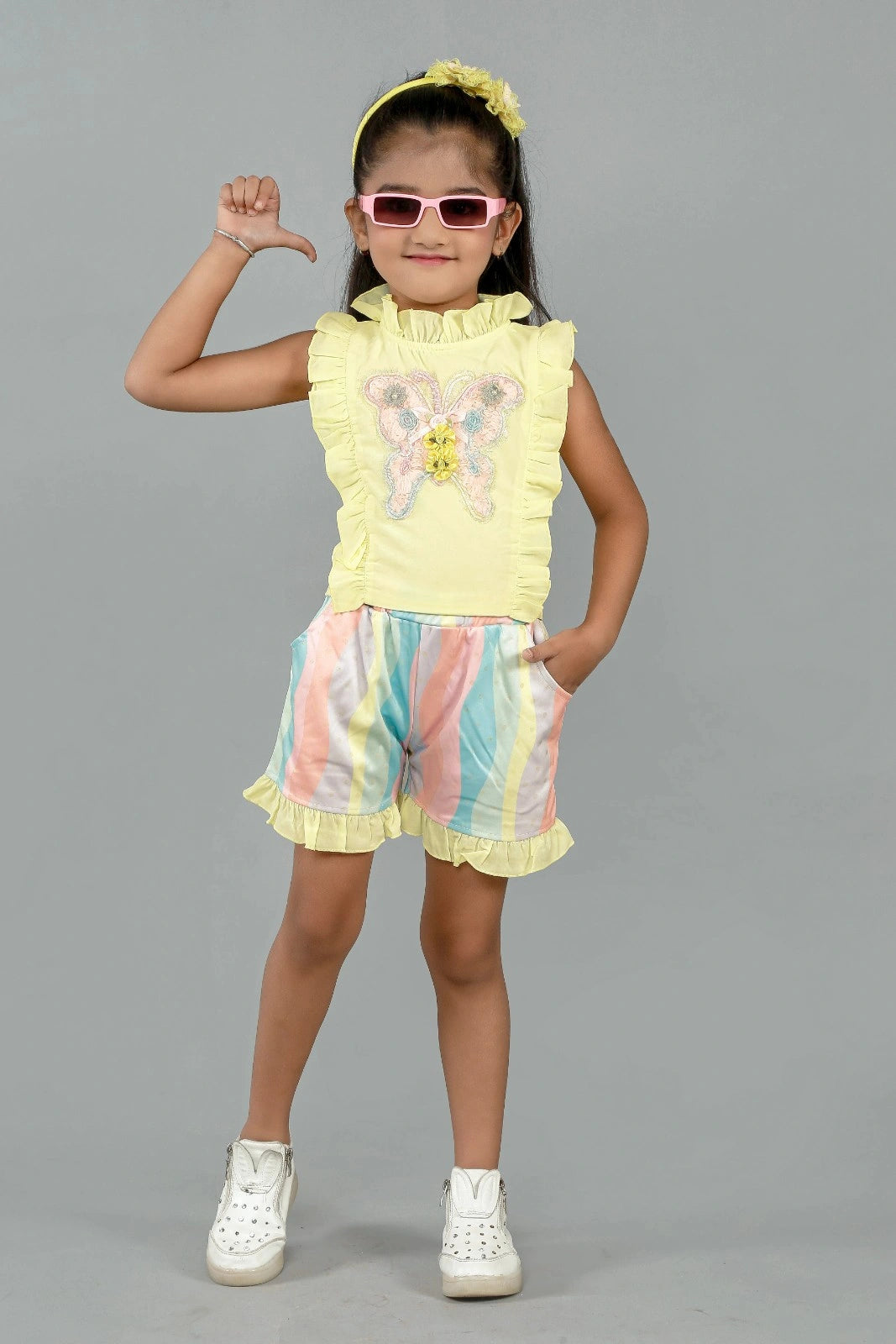 Eurynome Kidswear Girls – Ruffle top & pastel short set, butterfly appliqué, foil wave shorts, comfy chic for ages 3-9.