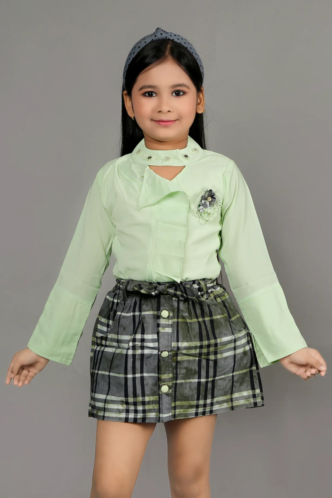 Eurynome Kidswear Girls – Lounge-Ready Round Neck Skirt & Top Set, Frilled Sleeves, Hand Embroidered Floral Broach, Extra Soft Checked Mini Skirt, Flower Knot Belt, Relaxed Chic Ages 3-6.